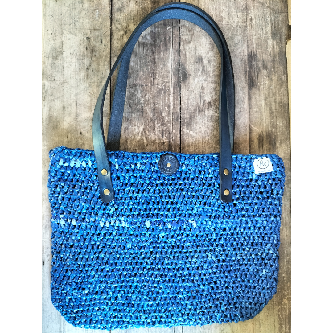 Navy blue upcycled plastic handbag with navy blue leather handles