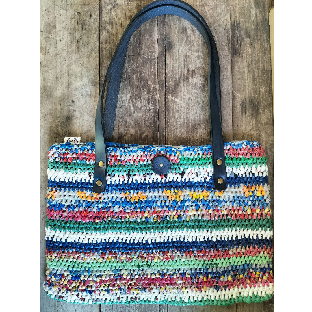 Multicoloured upcycled plastic handbag with navy blue leather handles